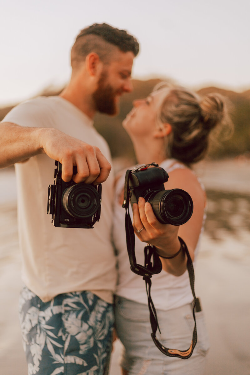 Idaho elopement photographers on holding cameras in Costa Rica.