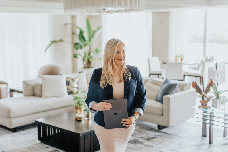 Woman holding a laptop and smiling