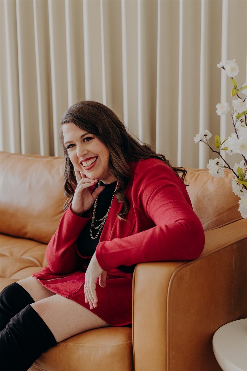 couple on couch with their legs crossed smiling