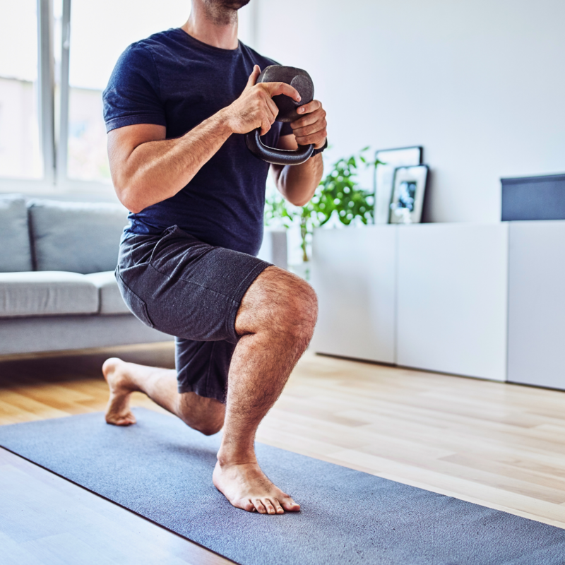 Man performing an at-home workout as part of Skopos Athletics' free 90-day training program, designed for strength and fitness anywhere.