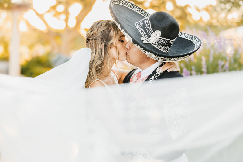 Mom holding and kissing her toddler daughter for a family photography session in San Luis Obispo