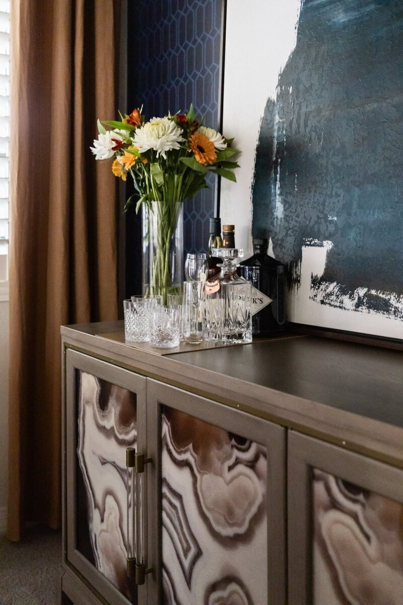 Luxury dining room by Stuart Design Co. with dramatic ceiling wallpaper, custom drapery, and artful styling