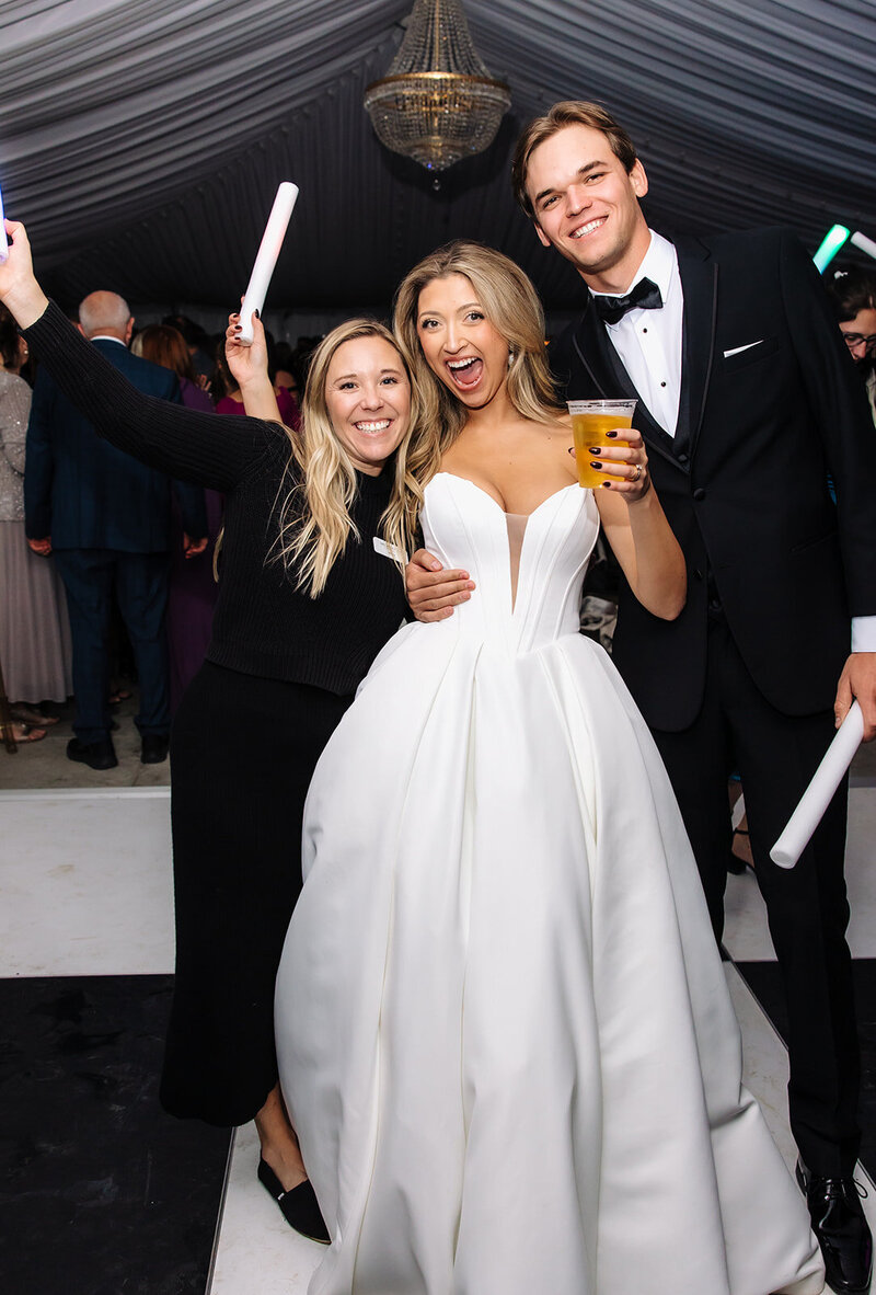 Shelby Donald of Shelby Donald & Company with newlywed couple on the dancefloor at their reception at The Cottage at Riverbend in Eagle, Idaho captured by Dear Kodak Photography