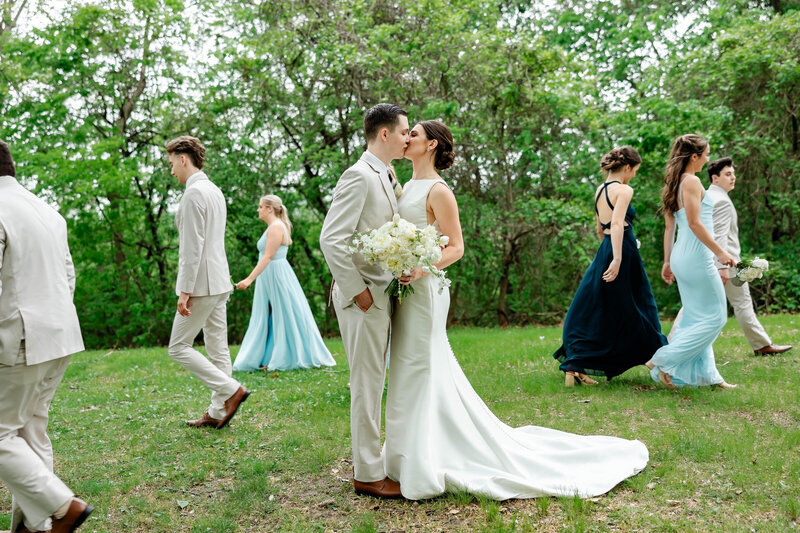 Fun and elegant bridal party photo captured by Style & Grace Photography at Indian Camp Creek, showcasing the bride, groom, and their closest friends celebrating the big day in a beautiful outdoor setting.