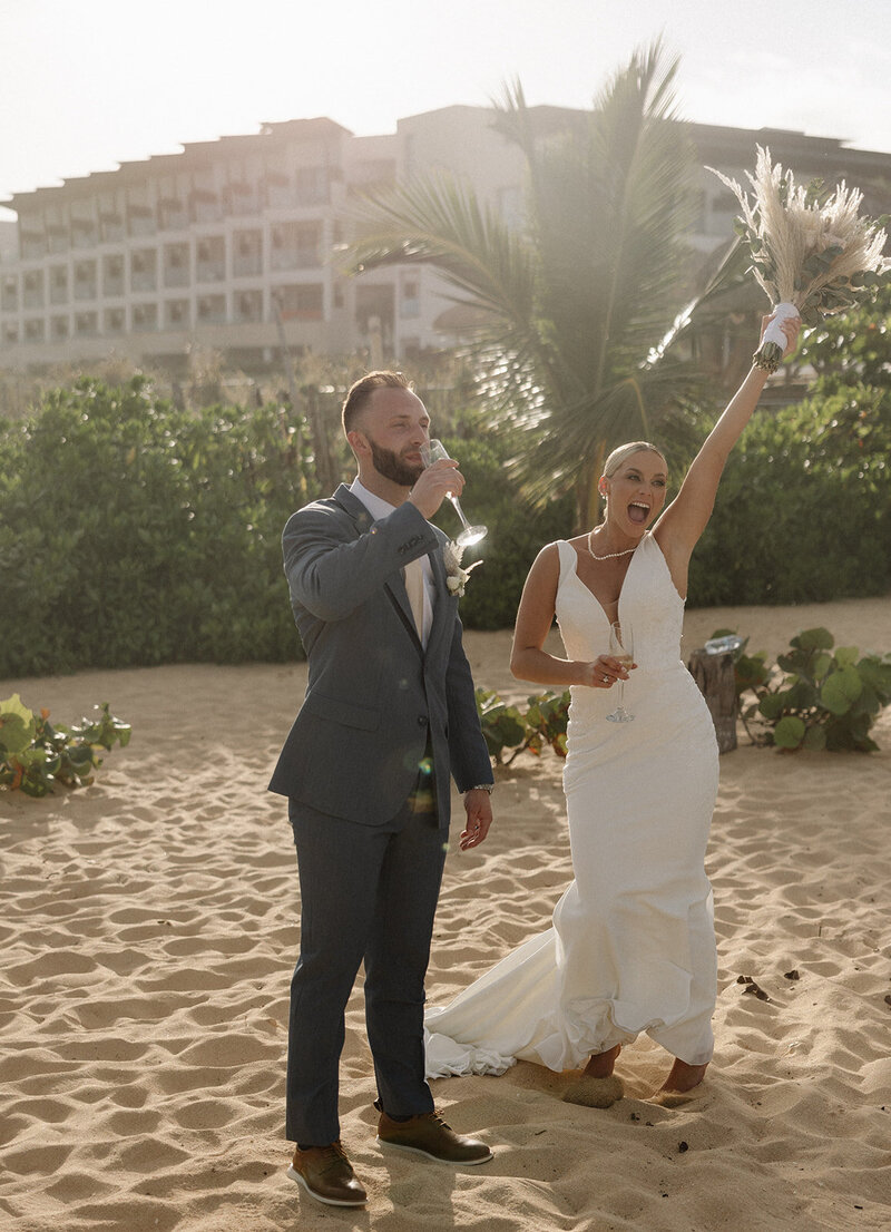 bride and groom celebrating with champagne