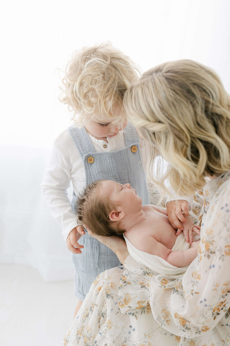 a mom with her newborn and toddler