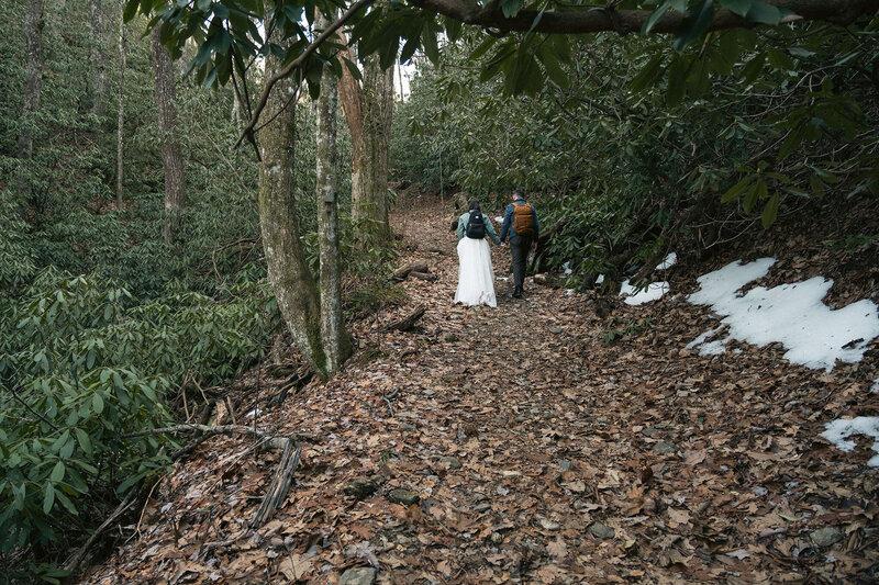 Elopement couple looking at each other as the sun sets in the mountains