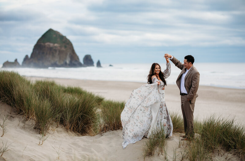 Bride and groom walking hand-in-hand along the sandy Oregon Coast, captured by an Oregon Coast Elopement and Wedding Photographer.