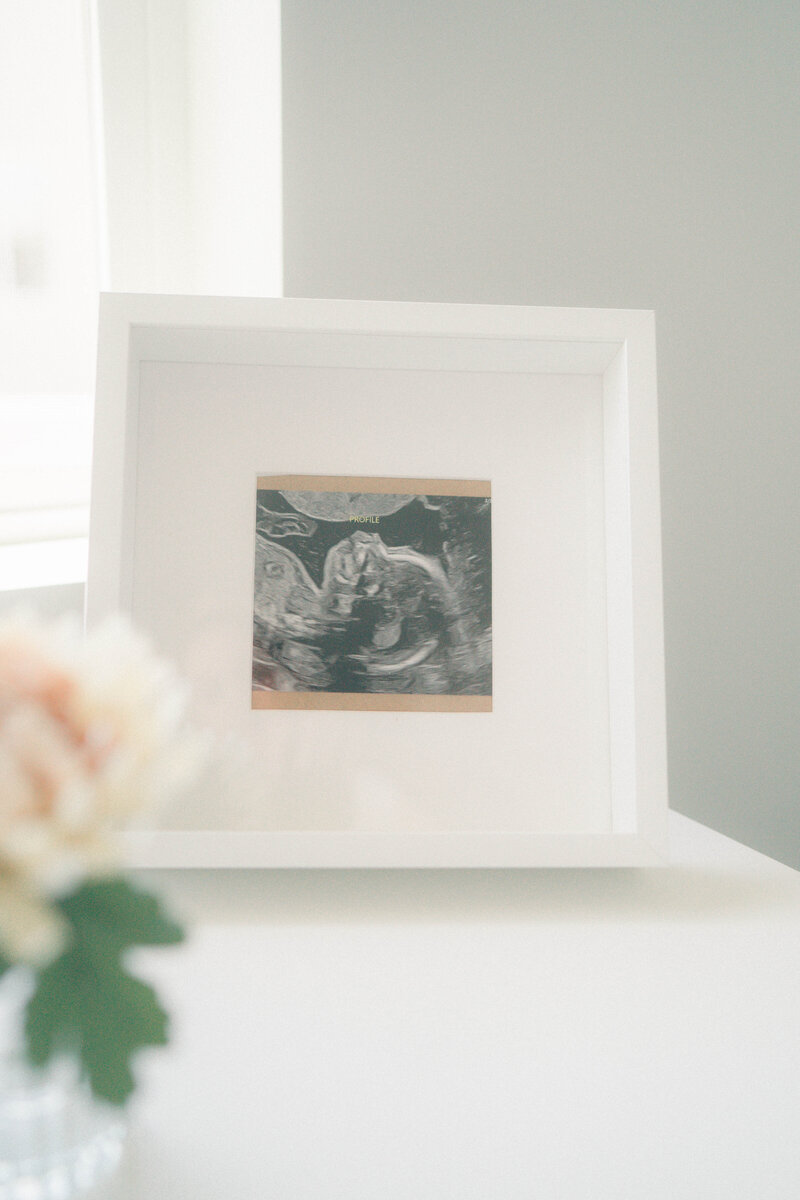 Natural newborn photography session in Riverton with warm, cozy nursery details.