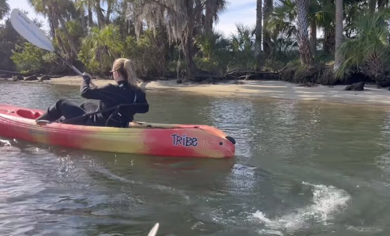woman in wetsuit kayaking