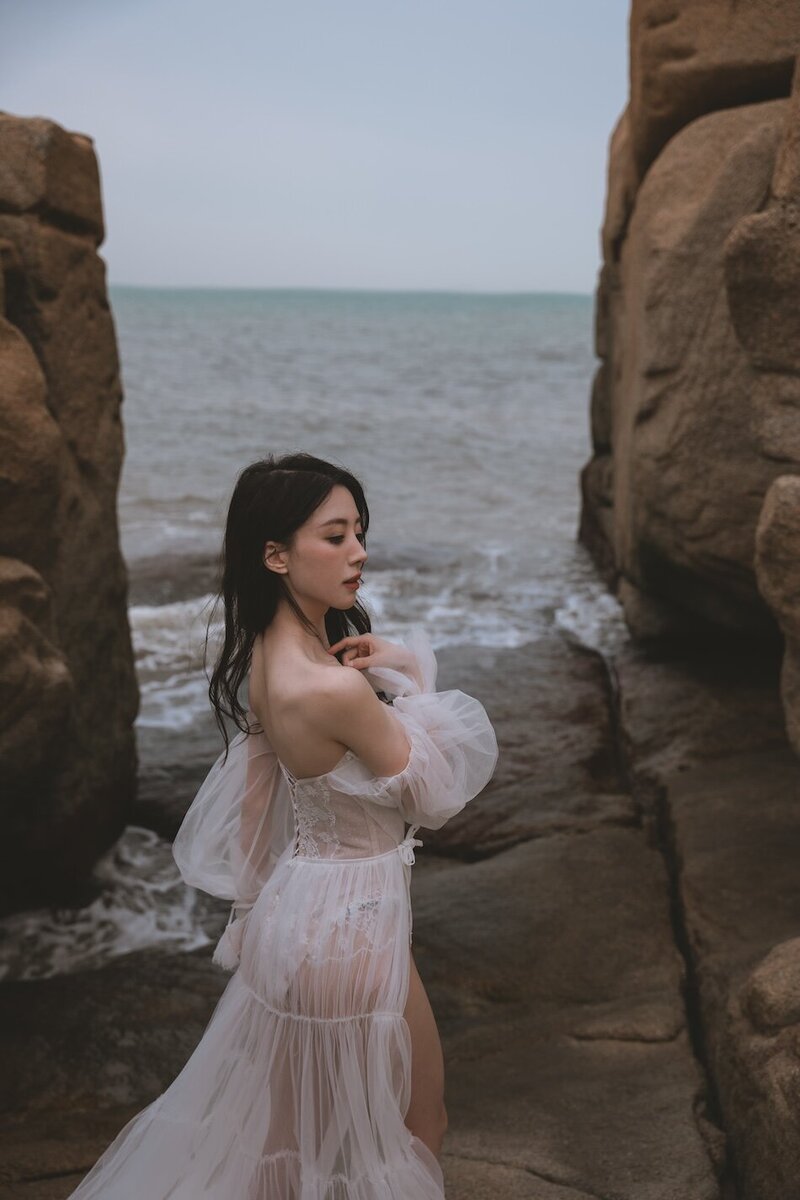 A beautiful windswept beach couture shoot amongst coastal rocks.