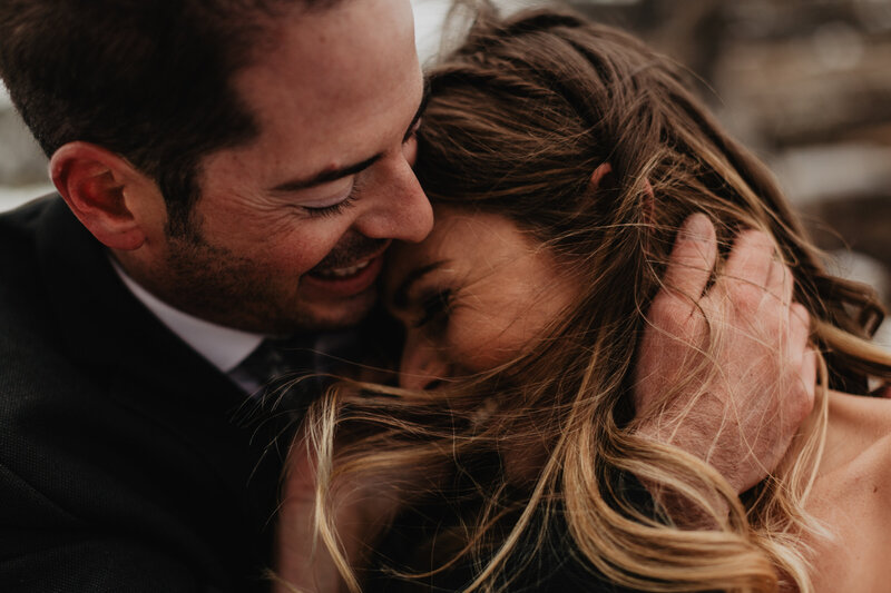 Wedding couple laughing in each other's arms during their Colorado elopement