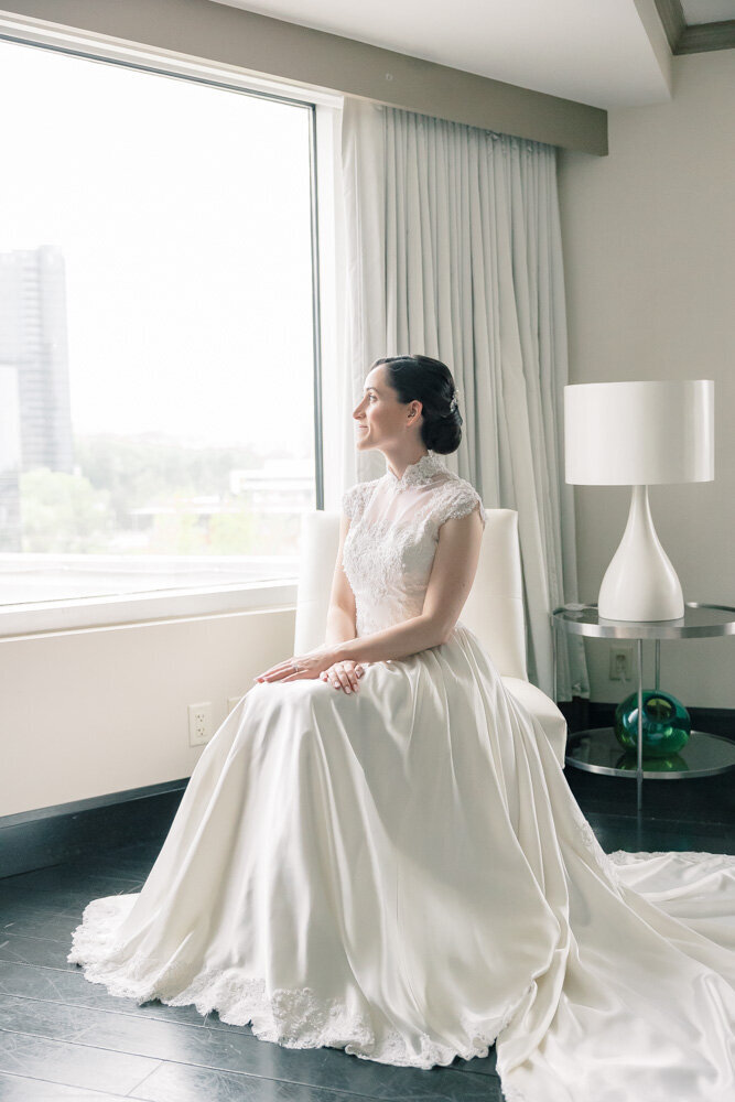 Atlanta Photographer Bridal Portraits | Bride sitting near a window wearing a customized version of her mother's wedding dress