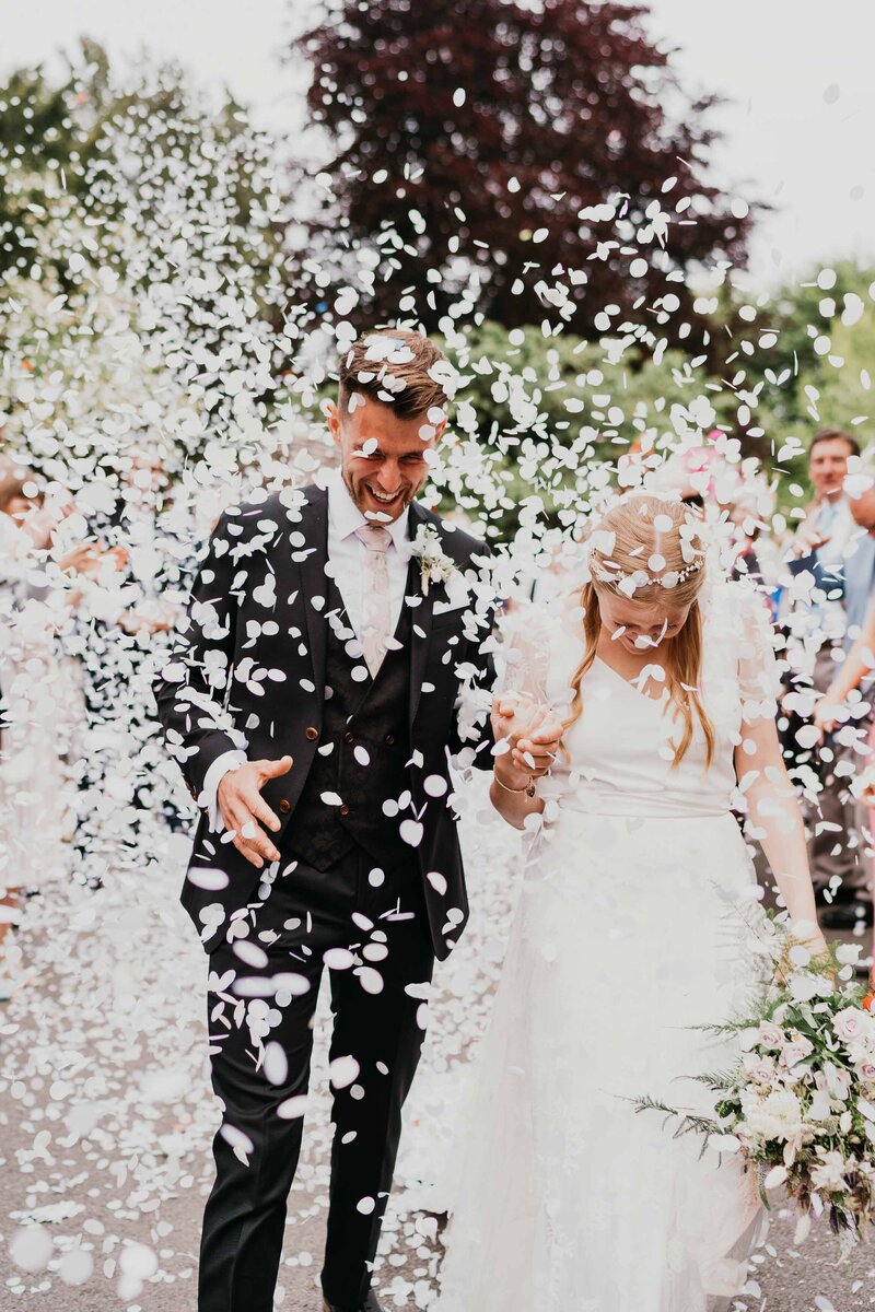 Couple showered in confetti tunnel in Epsom Wedding