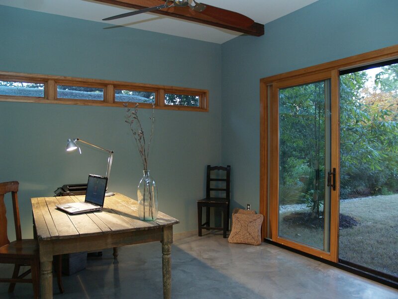 luxury office space in home. modern and minimalist home office with sliding glass door to garden.