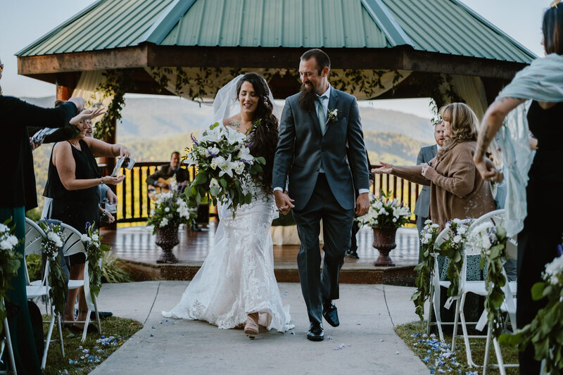Couple walking down the aisle after their destination wedding at Brothers Cove Lodge