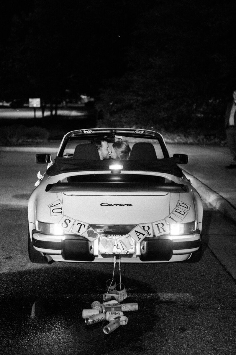 Classic getaway car with "Just Married" decorations outside Colonial Williamsburg wedding, captured by Morgan Renee Photography