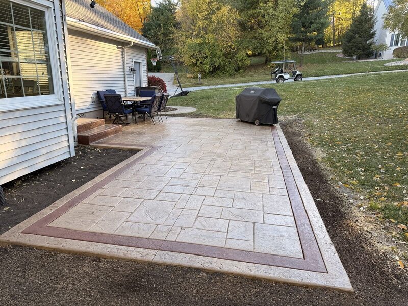 Stamped concrete patio with a color border and patio furniture in Middlebury, IN