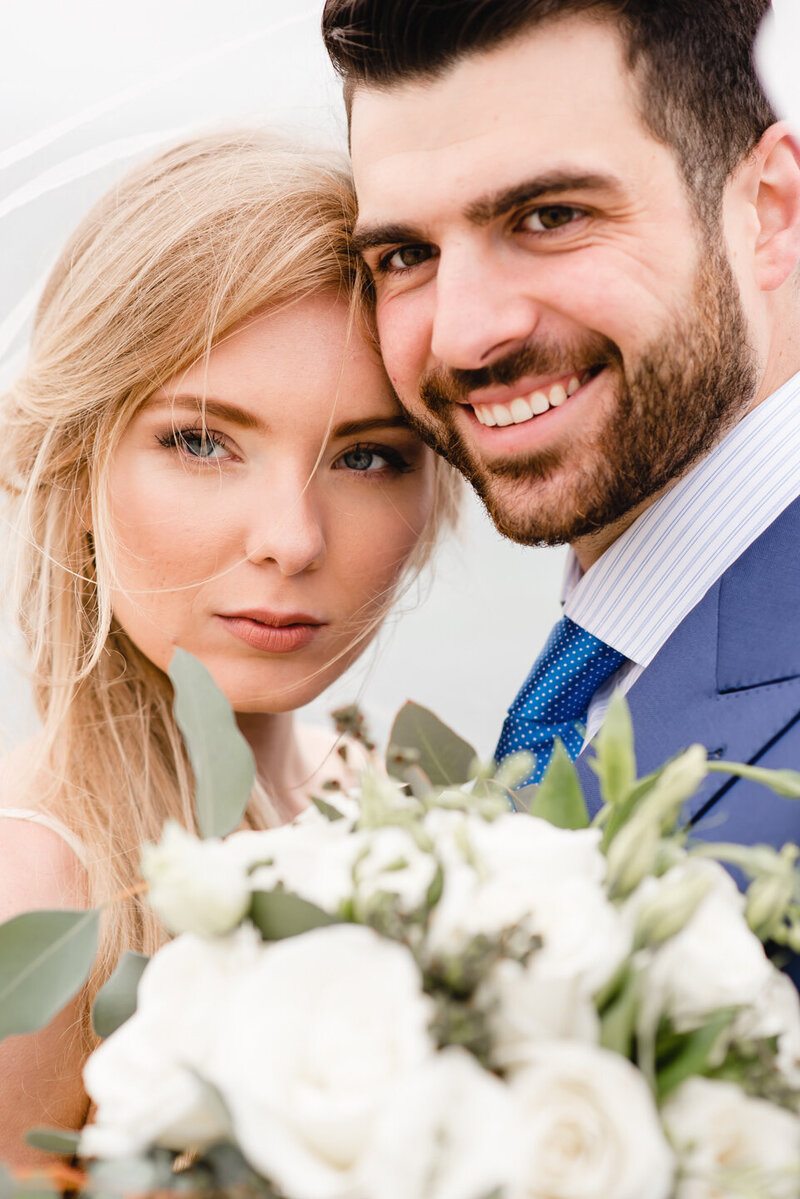 bride and groom smiling at the camera