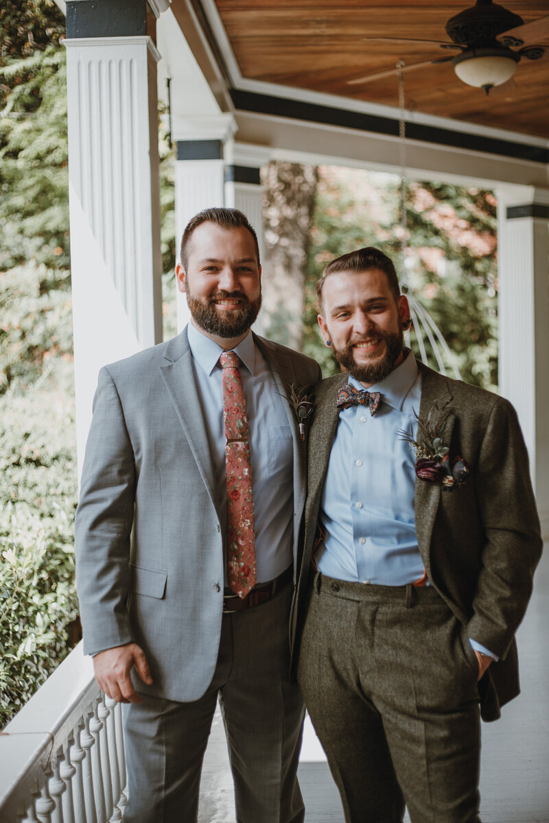 groom and male friend smiling