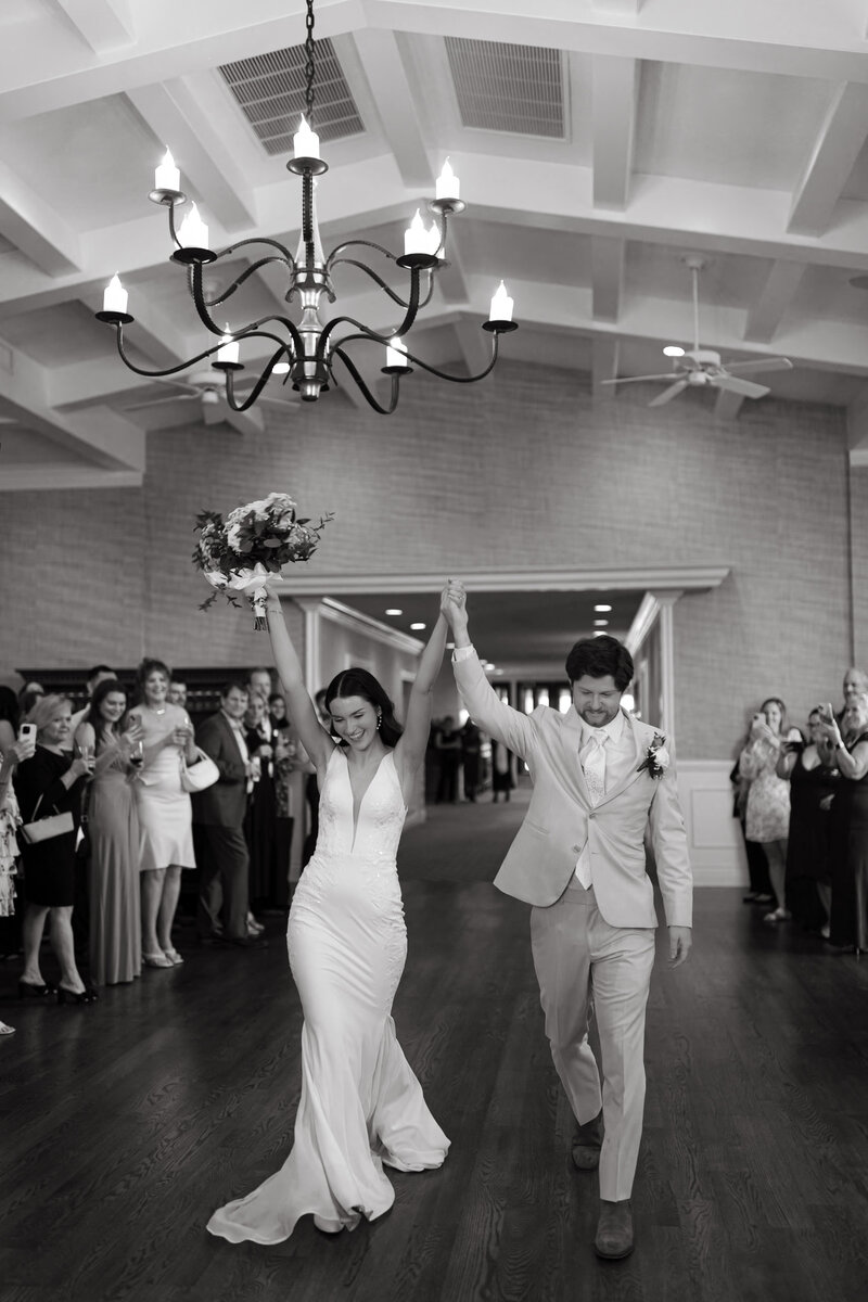 Bride and Groom celebrating their wedding in front of classic car
