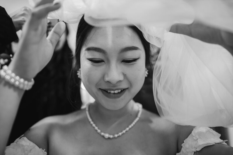 Bride puts on her wedding veil