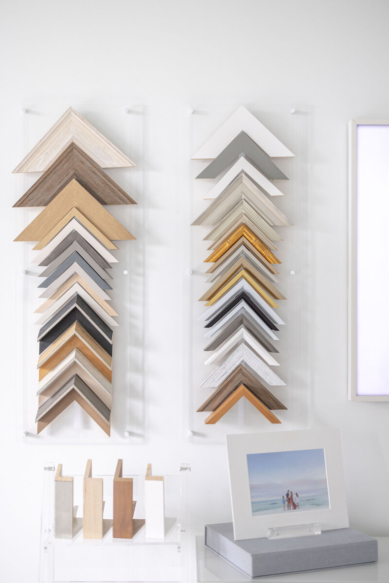 Various frame samples hung up on a wall