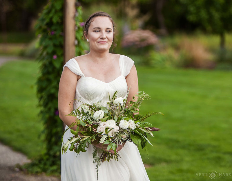 Bride walks down the long dirt aisle at Chatfield Farms Denver Botanic Gardens