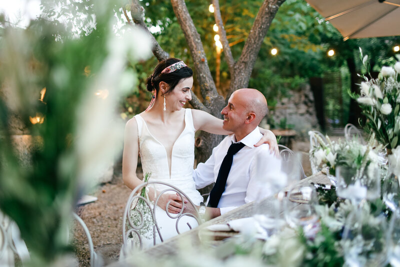 bride-sitting-on-grooms-lap-at-luxury-wedding-in-cotignac