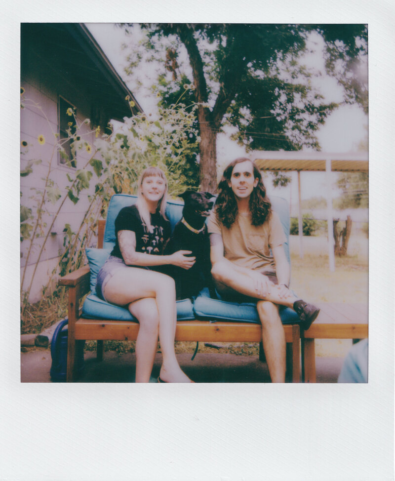 polaroid of couple with dog