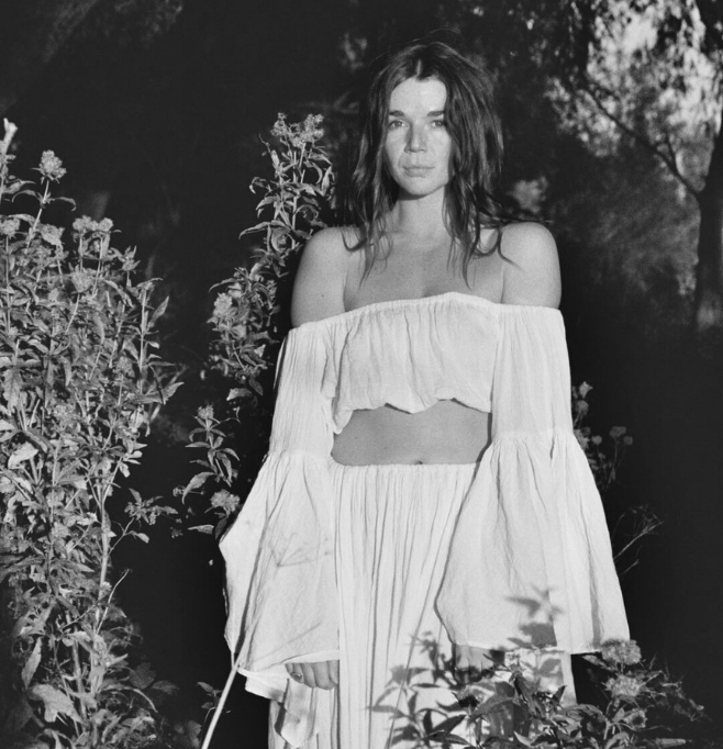 Girl at women's retreat folding her hands to the sky