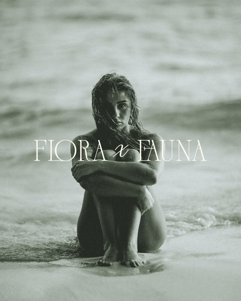A serene, monochromatic image of a woman sitting in nature with the text "Flora x Fauna" overlaid. The scene reflects the brand’s ethos of finding beauty in nature and organic self-care.