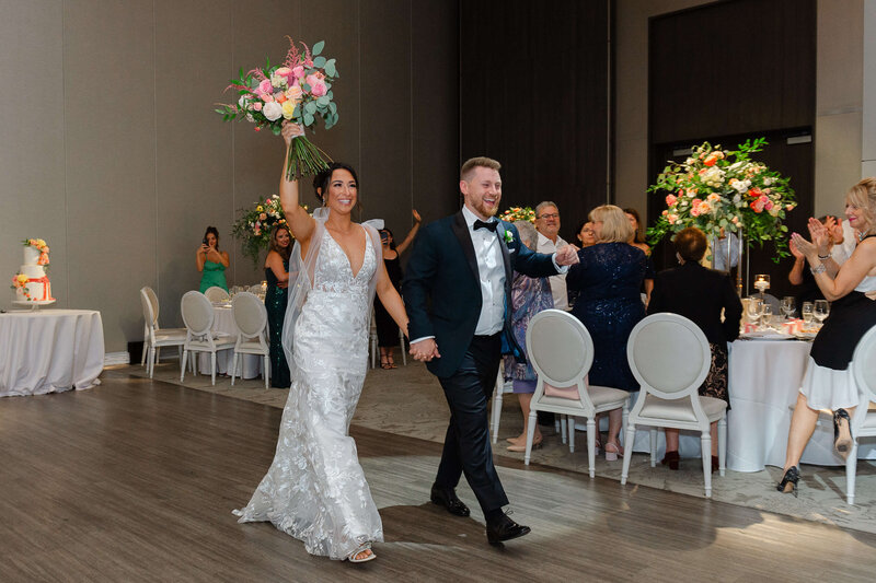 a bride and groom make their grand entrance at their Chateau Le Parc wedding.  Captured by Ottawa wedding photographer JEMMAN Photography