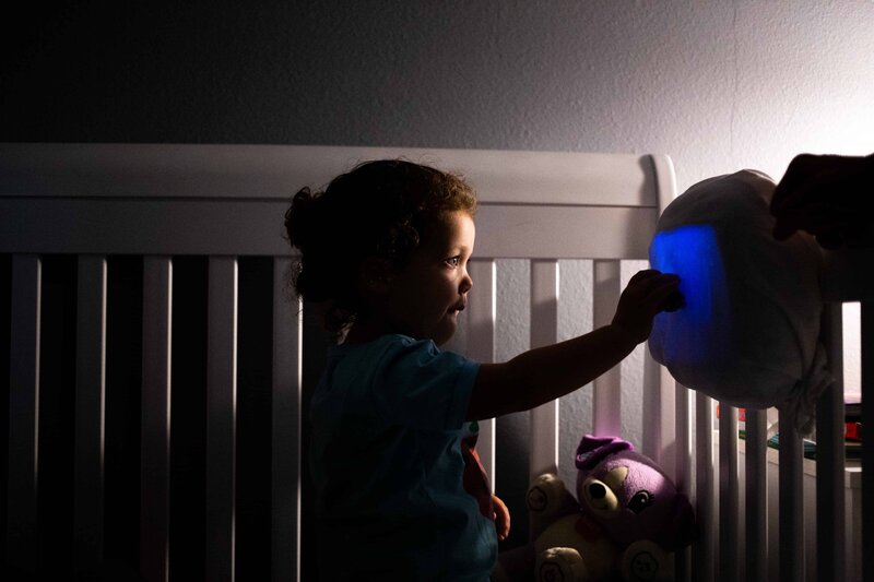 toddler looking at crib light at bedtime