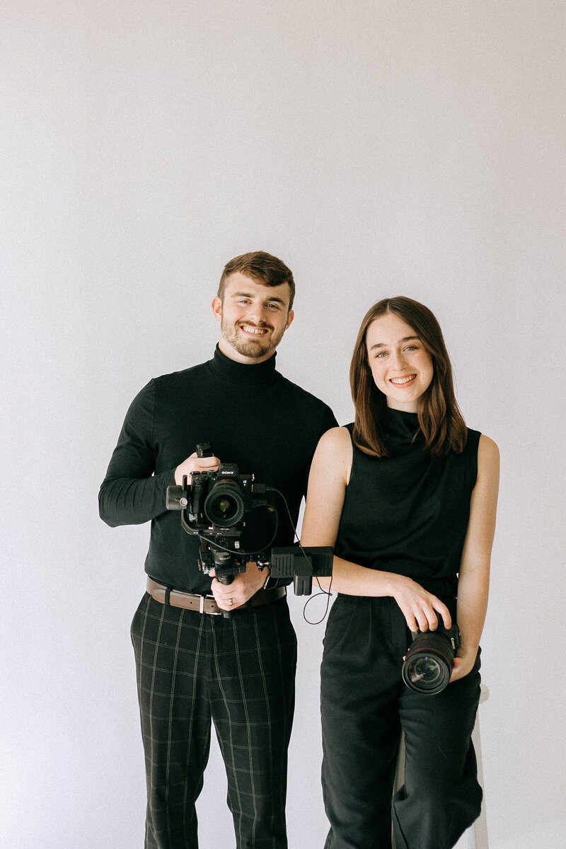 photographers smile at each other