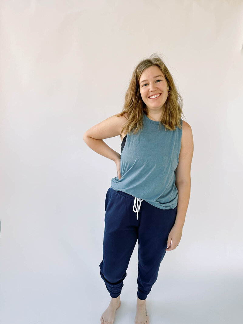 woman wearing navy jogger sweatpants and blue muscle tank