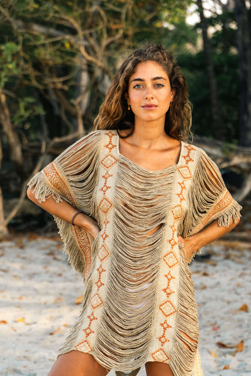 Model posing on beach with dress on