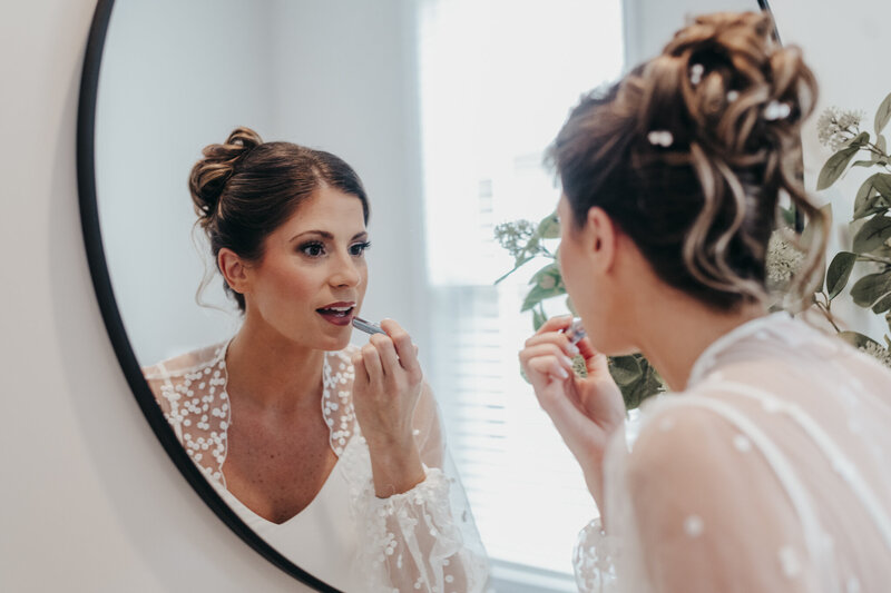 bride putting lipstick on