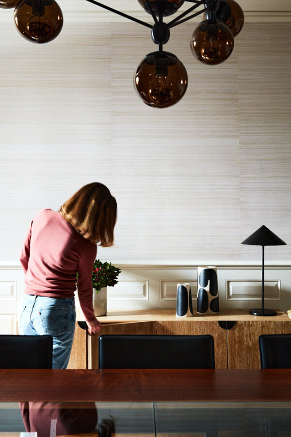 Sarah Scales, Boston based interior designer, in a modern dining room at a historic Boston home, blending old architecture with fresh interiors.