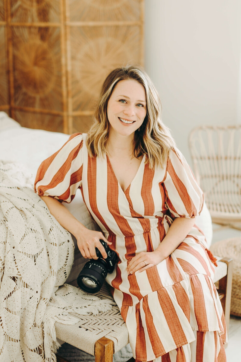 family photographer holding camera and smiling