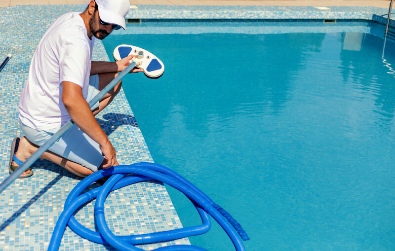 man completing swimming pool chemical balancing Chesapeake VA