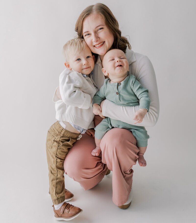 A mother poses with her children during a mommy-and-me session.