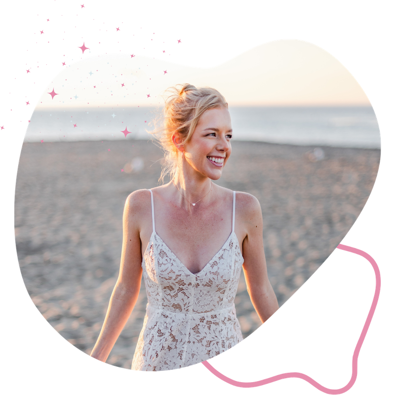 Blonde woman smiling with open arms at beach