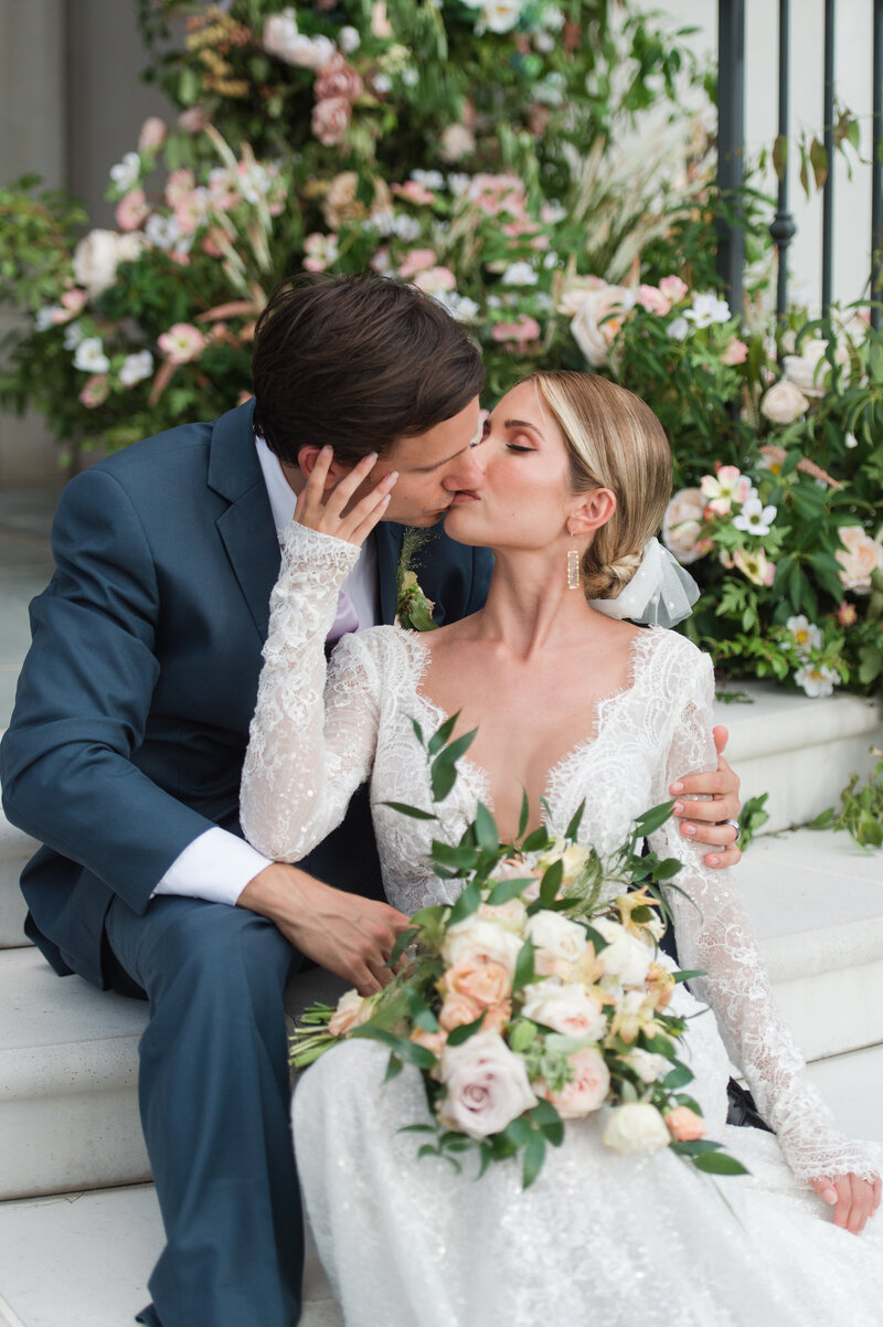 Bride and Groom kiss on the steps of the chapel at Park Chateau