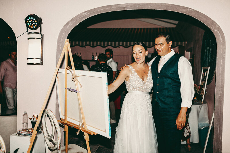 newly wed couple seeing their live event portrait for the first time