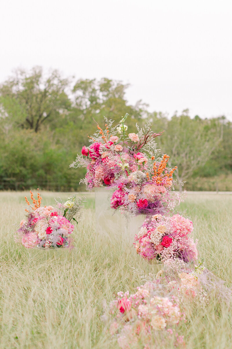 Pink modern flower arrangements in a grassy field