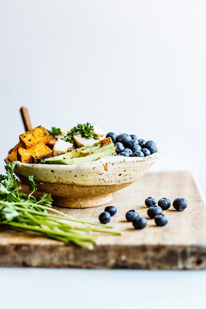 A beautifully styled bowl of fresh, vibrant ingredients, representing the healthy and nourishing approach to nutrition coaching at Wildseed Health.