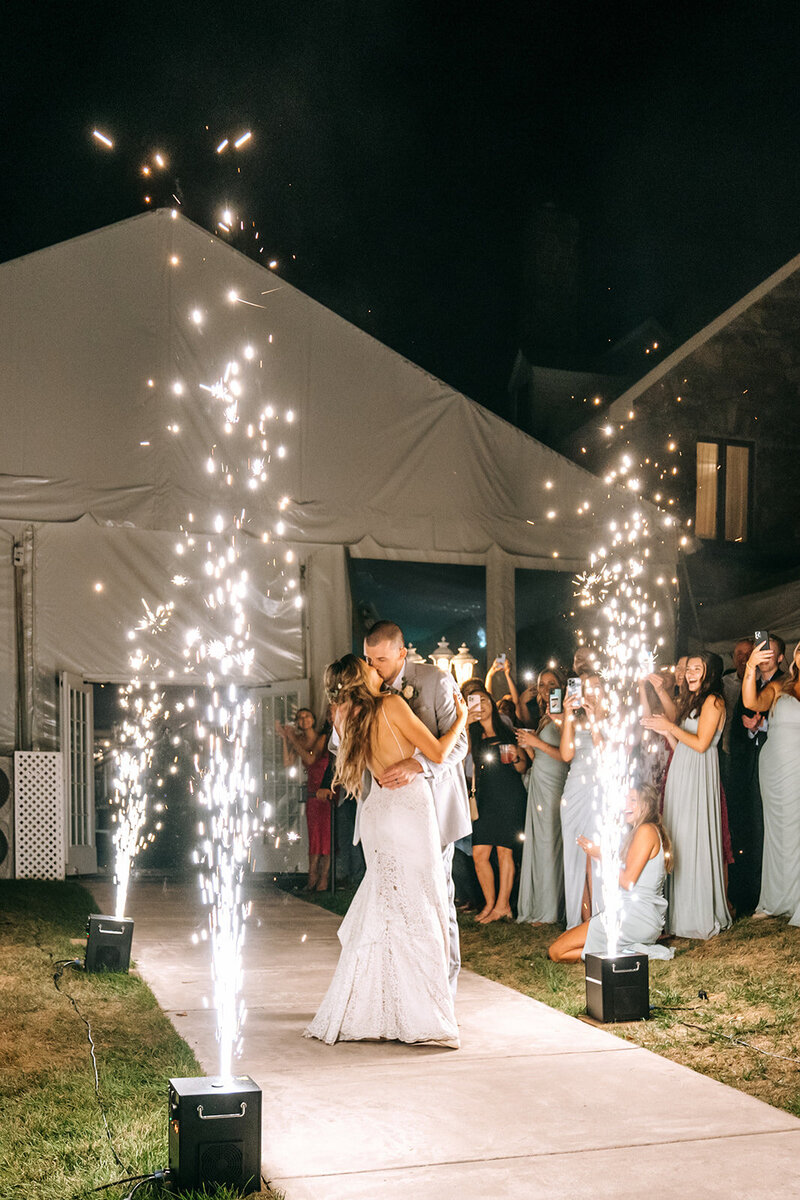 wedding sparkler exit with newlyweds kissing
