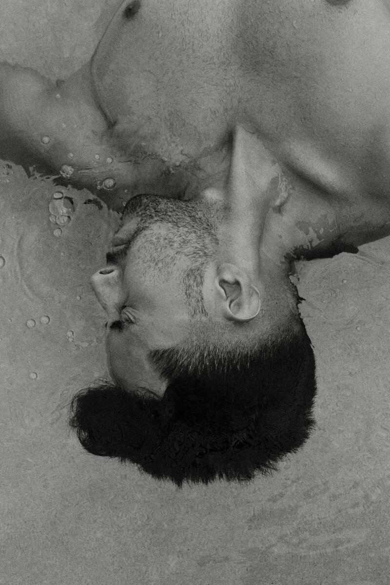 black and white photo of man underwater