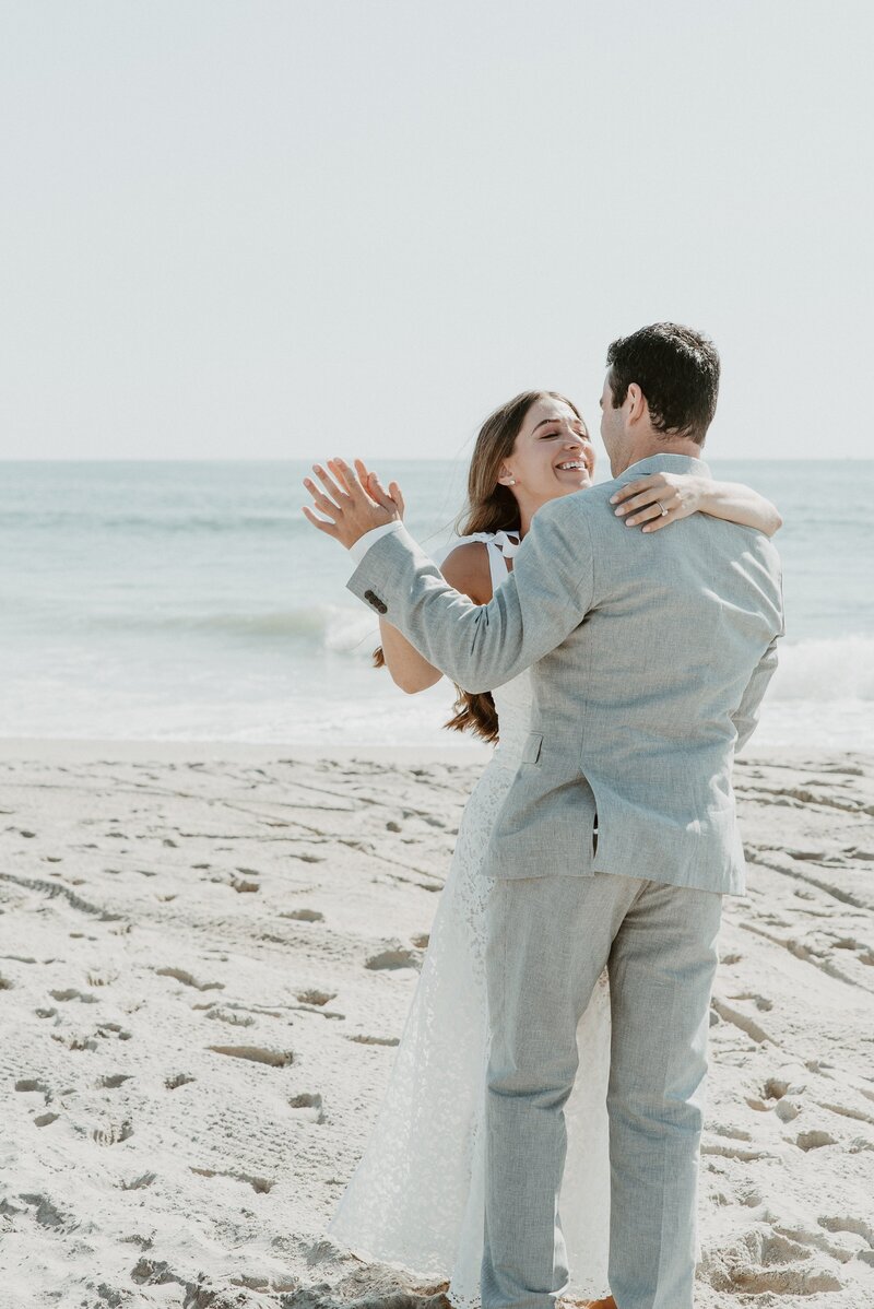 bride and groom dancing on beach at San Diego wedding